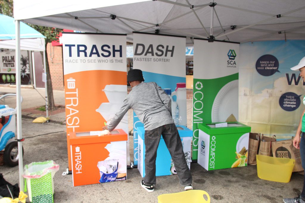 Participants race to sort trash, compost, and recycling for SCA's Trash Dash game at Greenfest. 