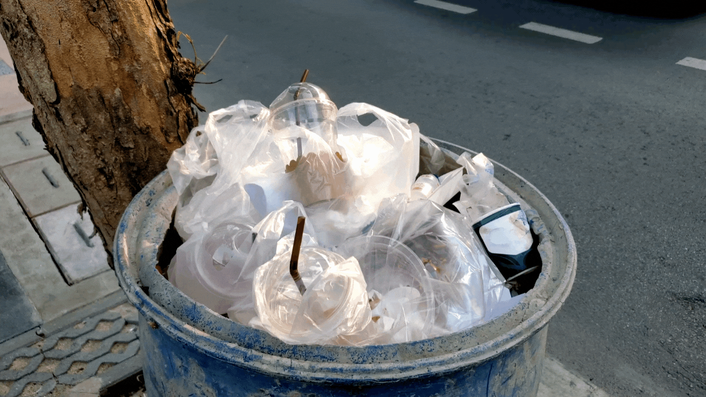 Plastic bags fill a trashcan