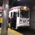 Riders board SEPTA trolley 36 at an underground station.