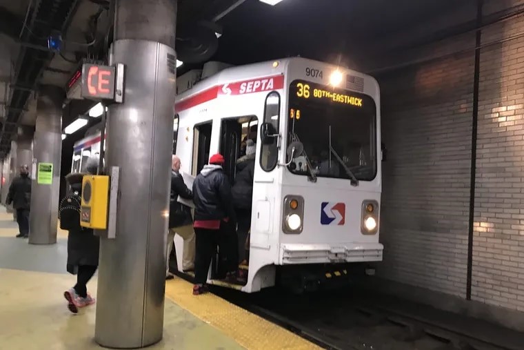 Riders board SEPTA trolley 36 at an underground station.