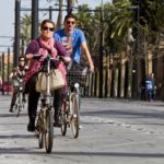 People biking and walking along the road