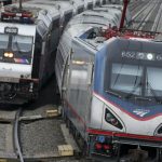 An Amtrak train passes a New Jersey Transit train