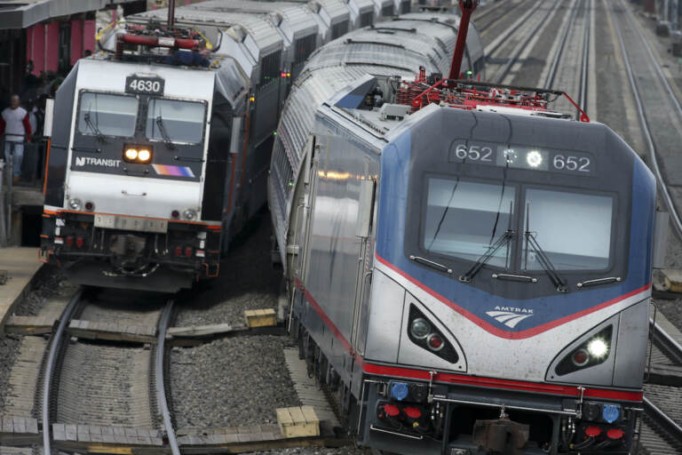 An Amtrak train passes a New Jersey Transit train