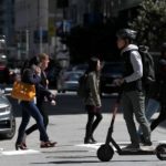 Scooter Rider and pedestrians crossing the street