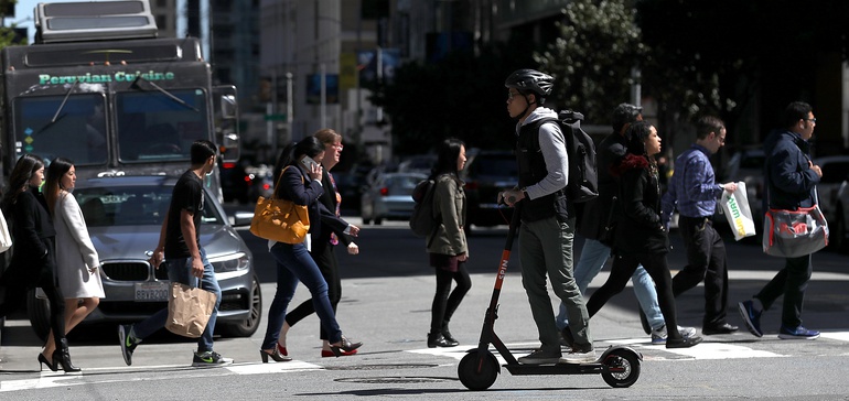 Scooter Rider and pedestrians crossing the street