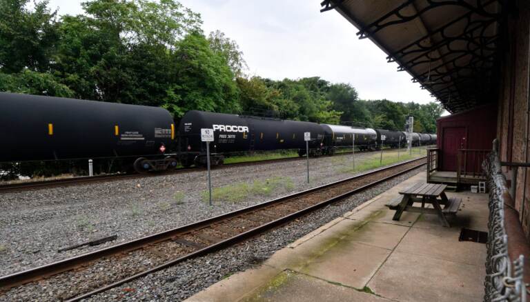 Freight train operated by Norfolk Southern rolls past the former train station in Phoenixville, Pa.