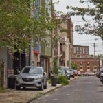 Cars are parked on the sidewalk on Fletcher Street in Philadelphia’s East Kensington neighborhood.