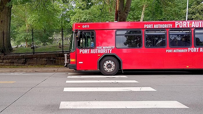 A Port Authority bus, parked by a crosswalk in Pittsburgh.