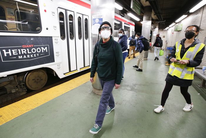 Volunteer Cameron Adamez looks around the SEPTA Trolley Line stop at the 15th Street Station as Camille Boggan, a research assistant at Penn's Center for Safe Mobility, takes notes.