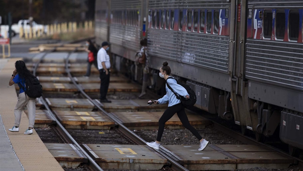 Passengers cross a track after alighting from a SEPTA train in Langhorne, Pa., last October.